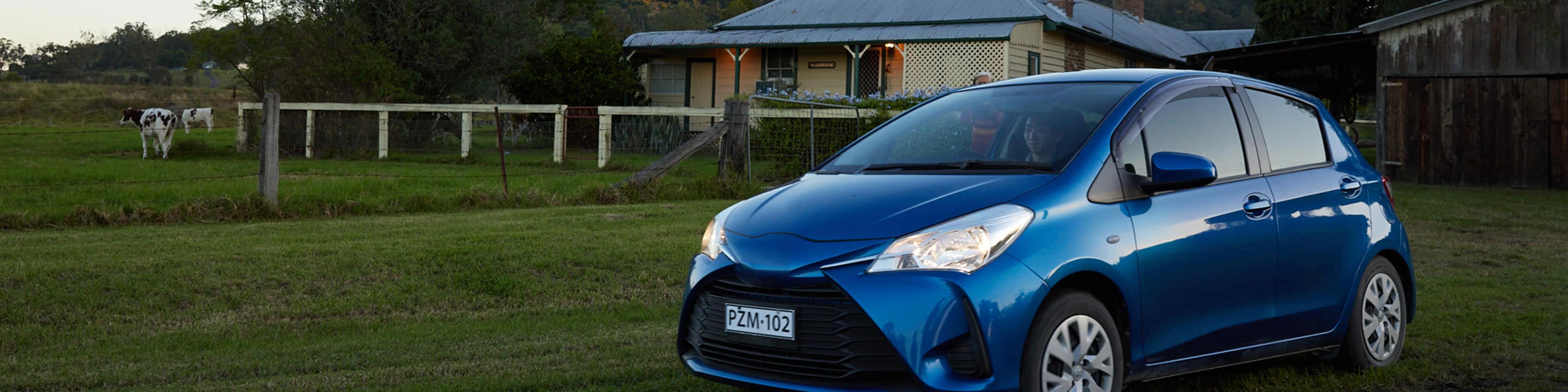 blue hatch parked outside Australian country farmhouse