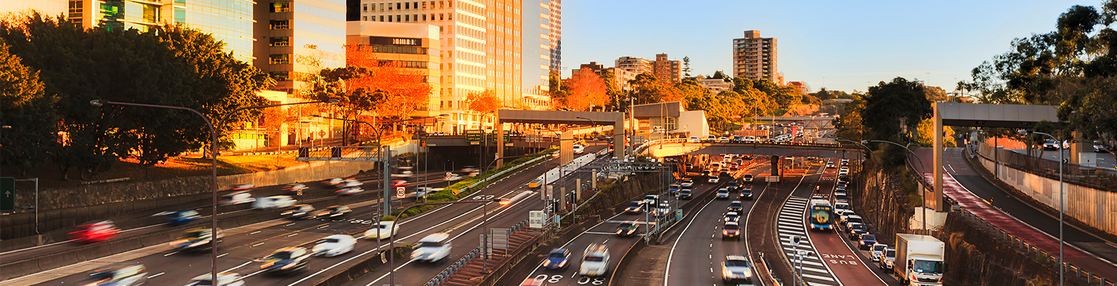 Cars driving on a freeway at sunset