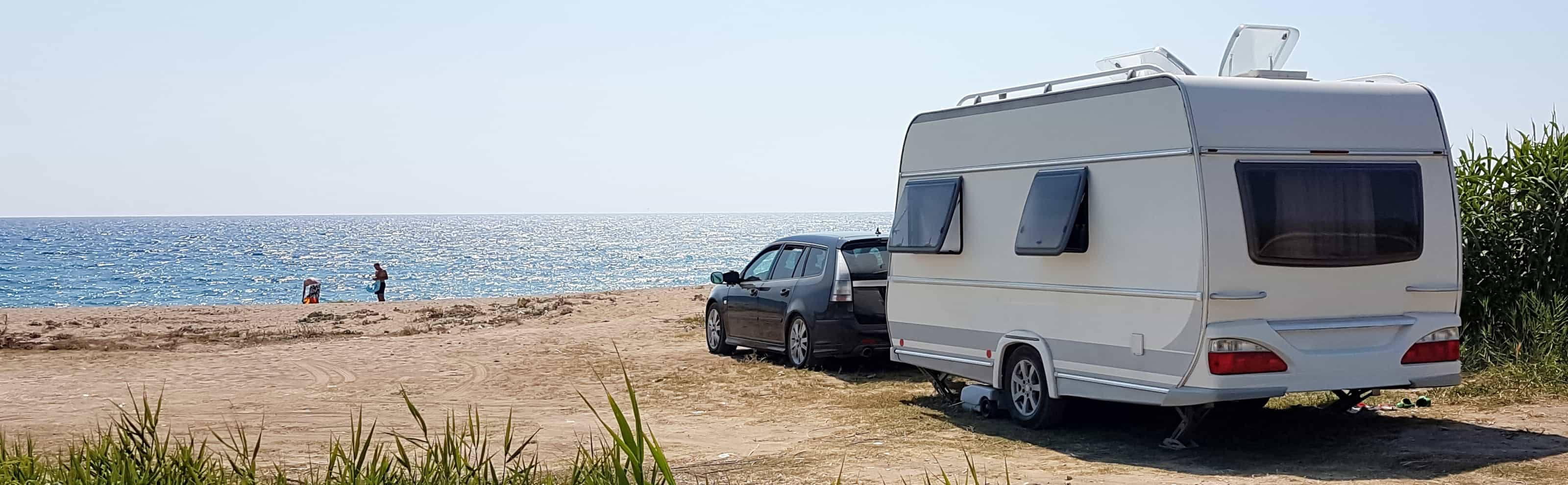 Couple enjoy caravaning on the beach