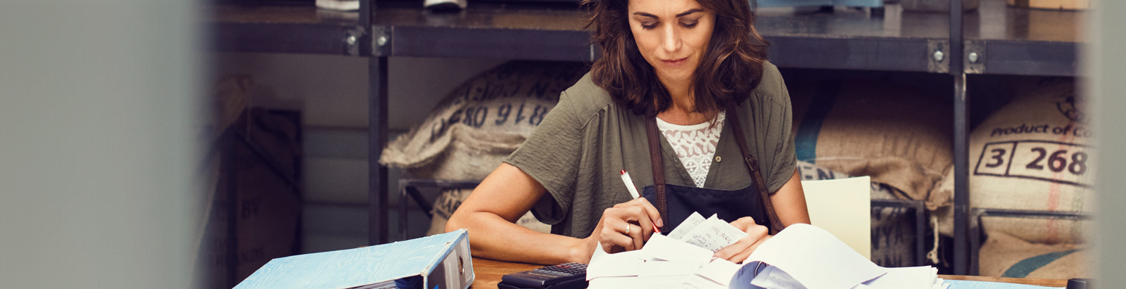 Woman in storage room working through papers