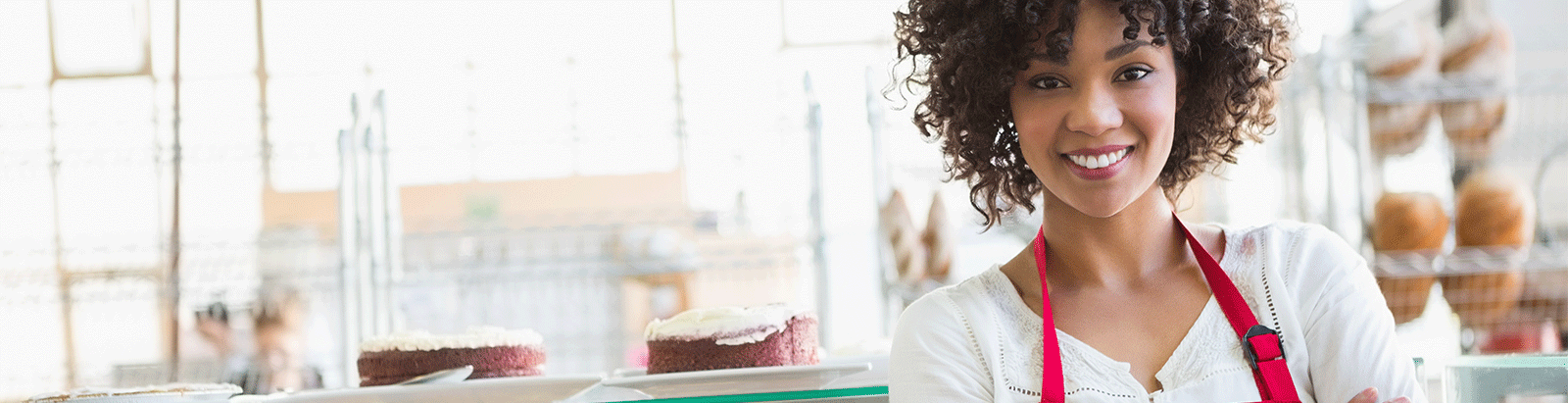 Female business owner smiling in bakery