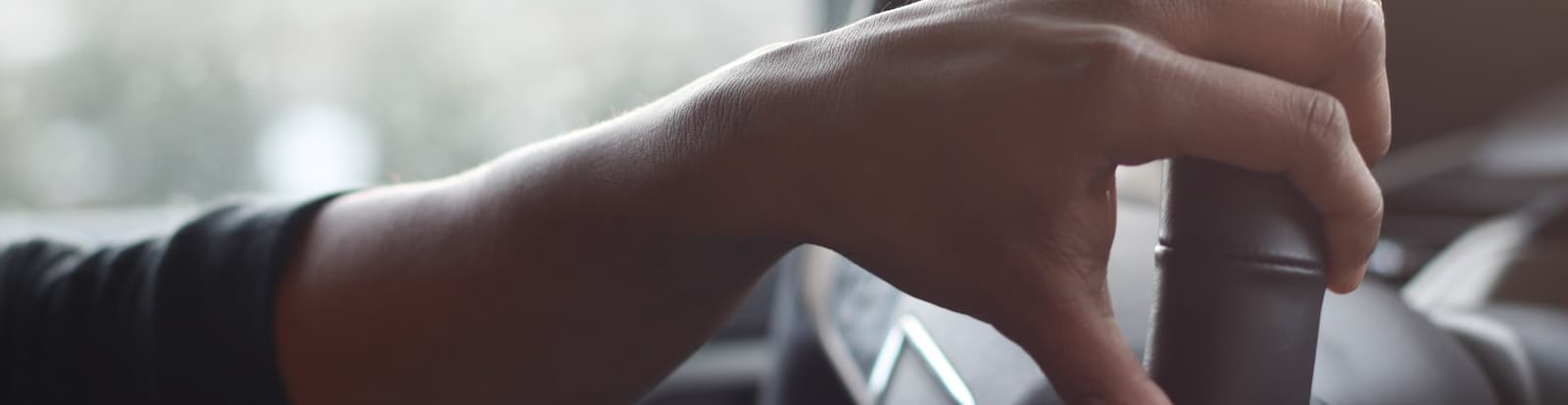 Hand holding steering wheel