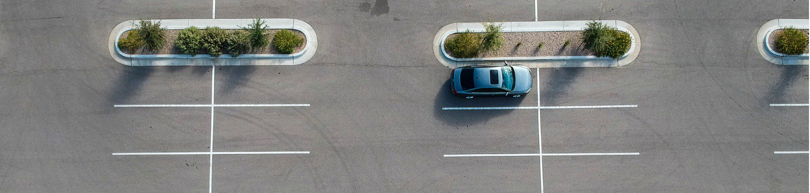 One blue car parked at the entire car parking.