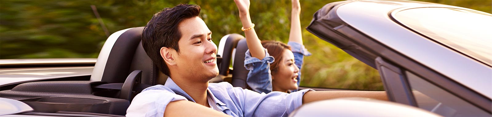 Couple driving in convertible car