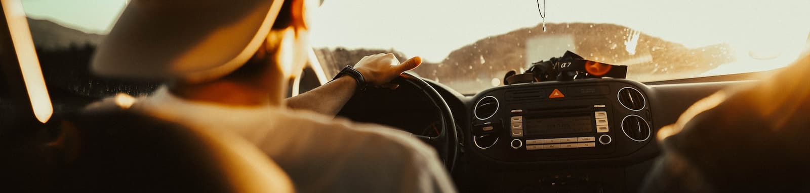 Man driving at sunset