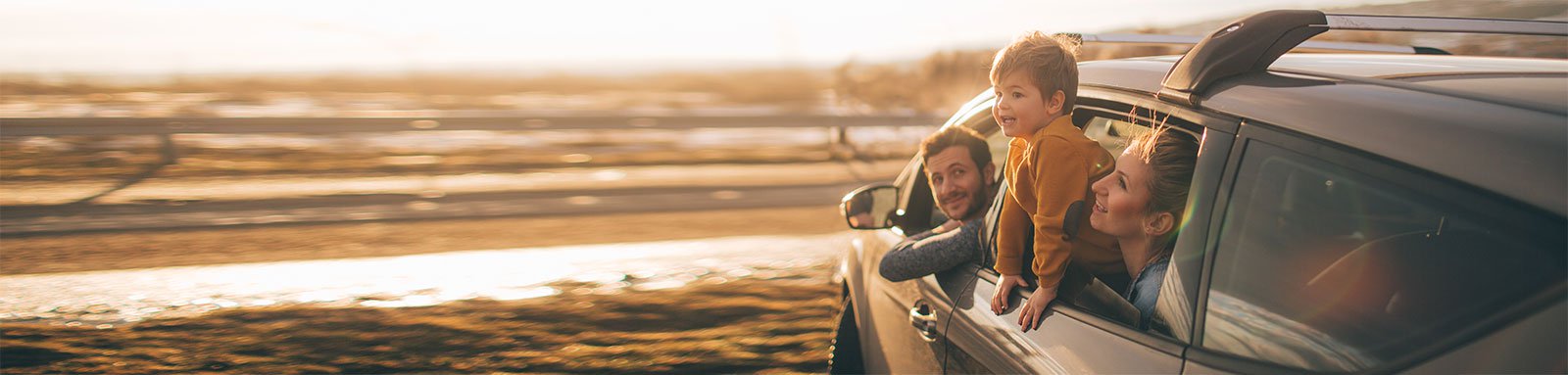 Family in a car looking at sunset