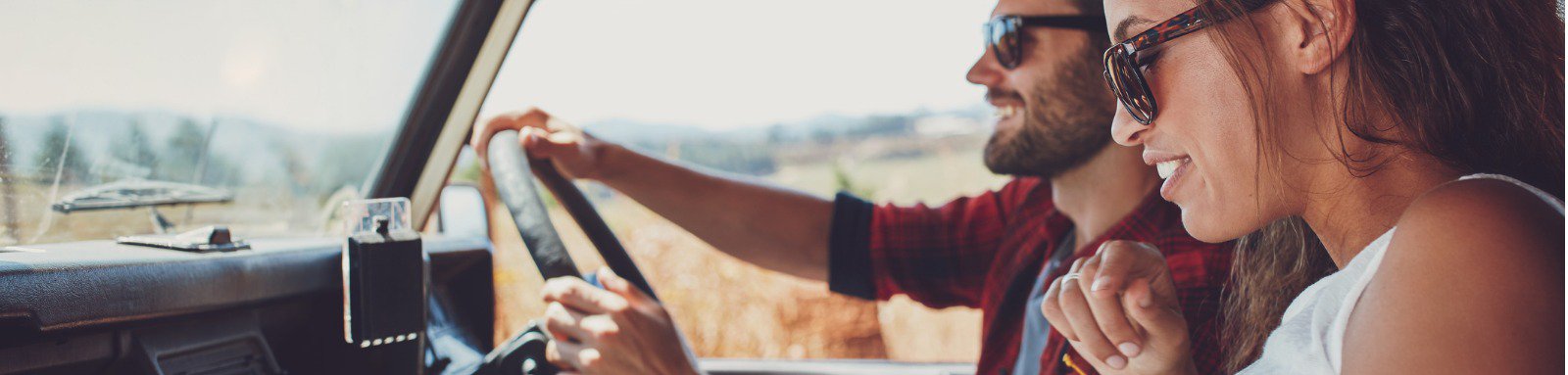 Man and woman in car consulting a map