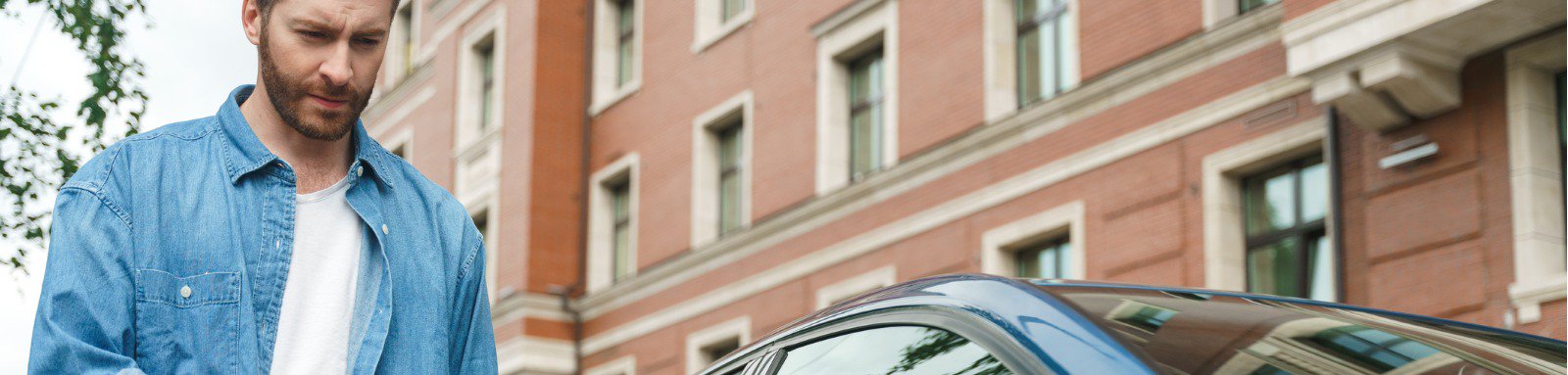 Man approaching door of parked car