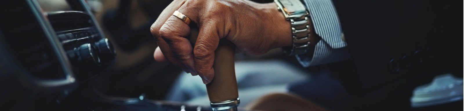 Man driving car with hand on gearstick