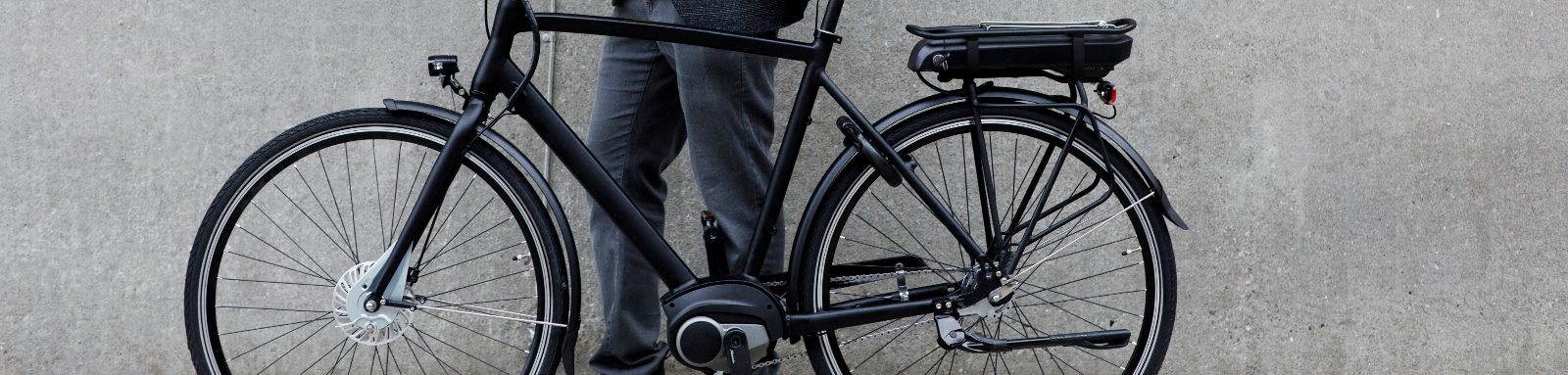 Man standing next to bicycle