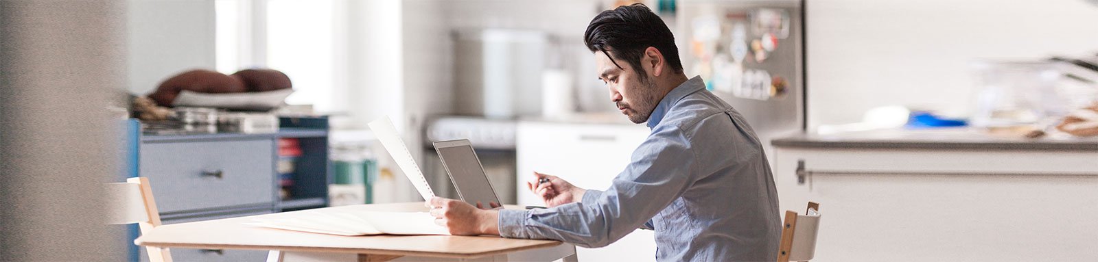 Man working at home looking at paper