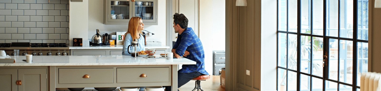 Man and woman talking in kitchen