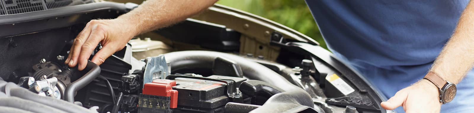 Person checking car engine