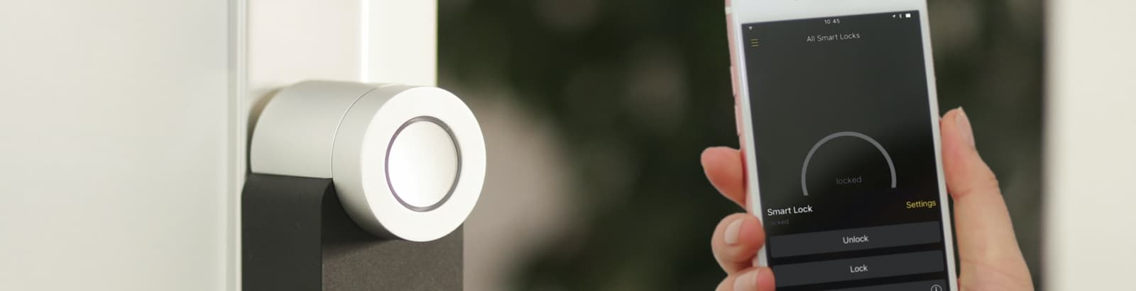 A smartphone next to a smart lock on a door