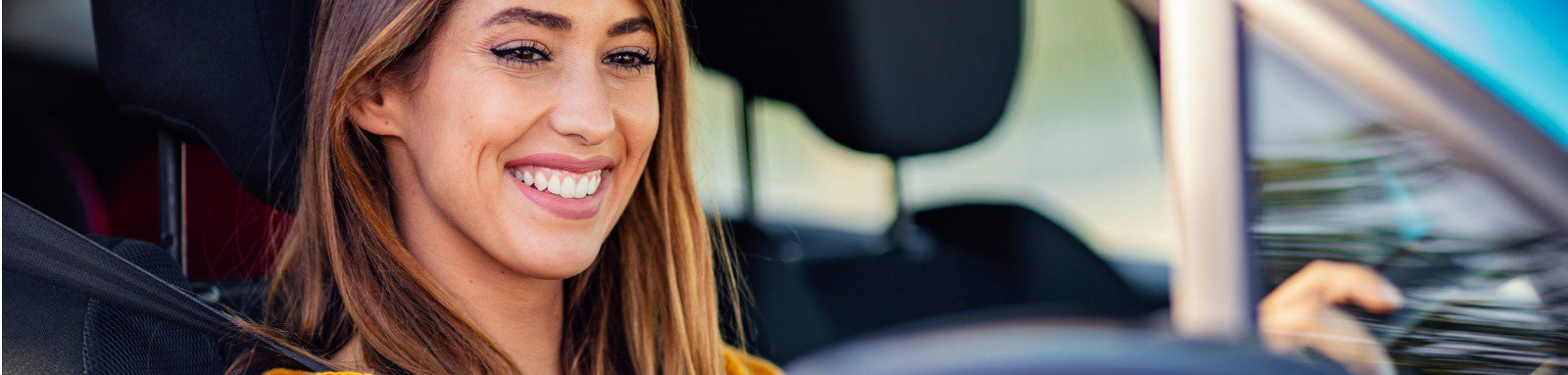 Smiling woman driving a car