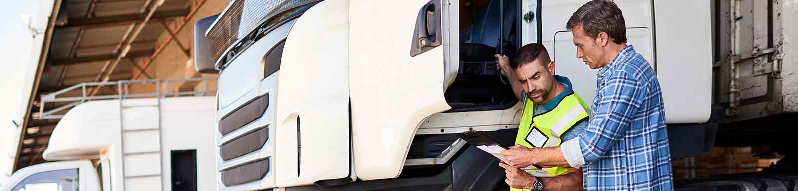 Two men infront of truck loading bay