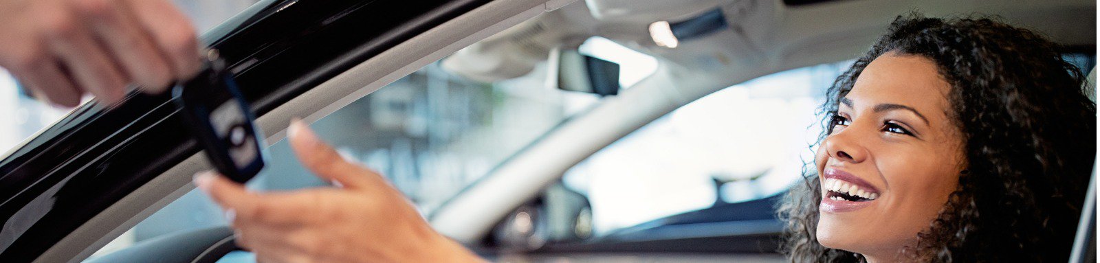 Woman accepting car key from inside car