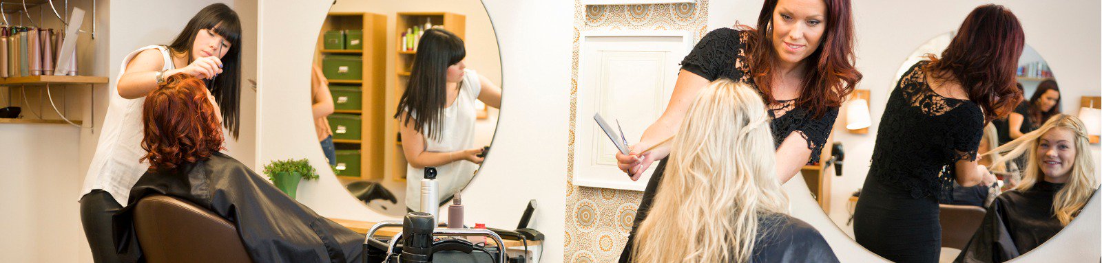 Women getting their hair cut at a salon