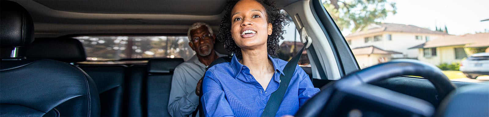 Young woman driving car for rideshare