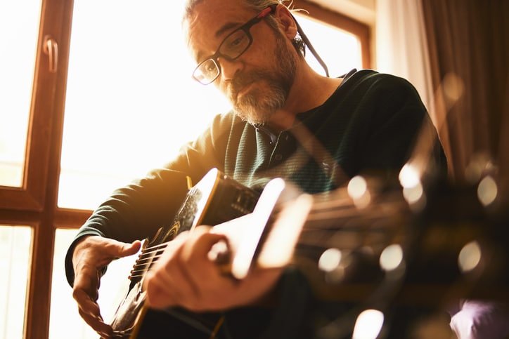 Man plays accoustic guitar