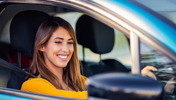 Smiling woman driving a car