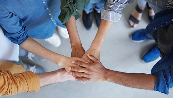 Workers holding hands 