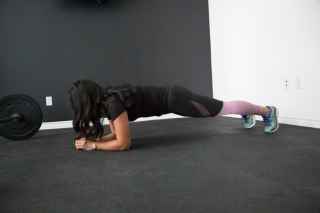 Woman in plank position at home